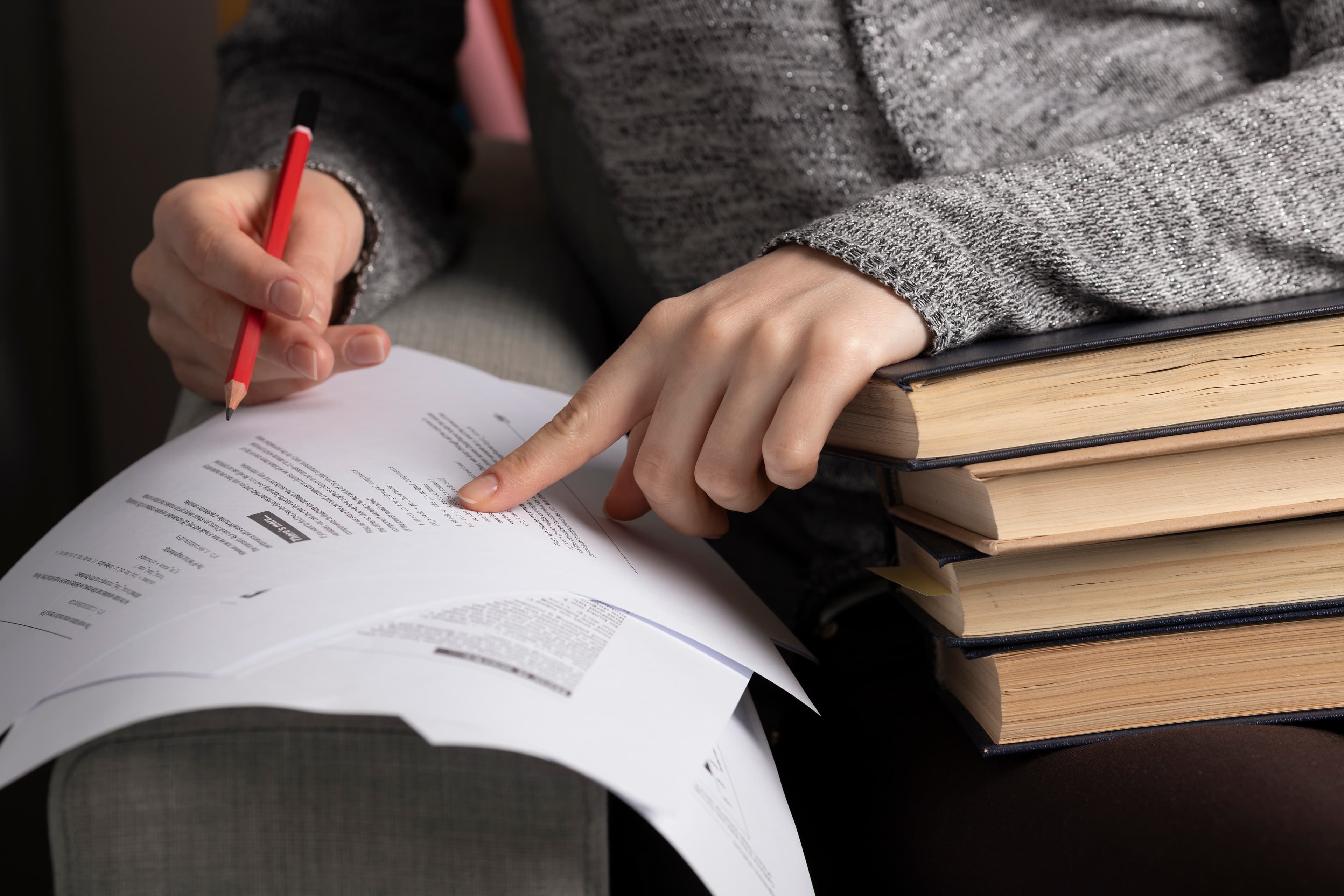 A teacher designing a grading rubric at a desk